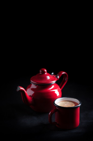 Porcelain teapot in red saturated retro-style and foreground
の写真素材