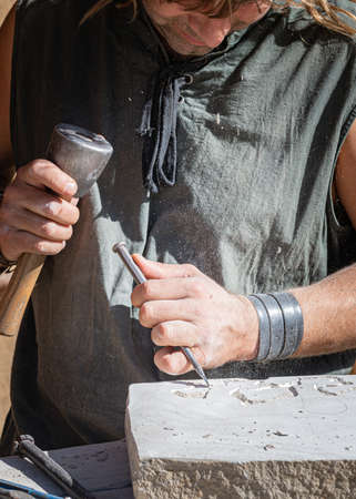 catching craftsman working in craft trade during the medieval days held in the city of Avila, Spain, during the month of September 2019のeditorial素材