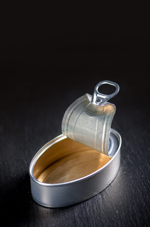 egg inside can of aluminum canned on a black background