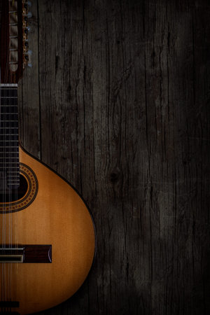 Acoustic guitar on old wooden background with copy space for text.