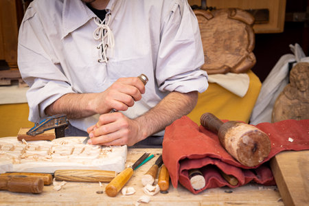 City of El Ãlamo, Madrid-Spain, Celebration of the medieval market with wood artisan in the foreground, held on May 04, 2024 representing the ancient medieval tradesの写真素材