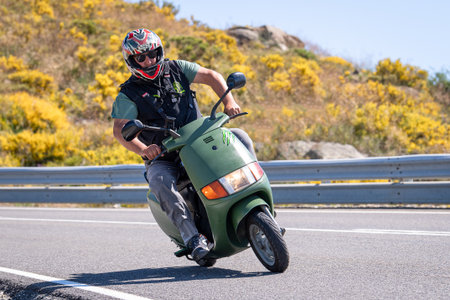 Man on motorcycle carving a tight bend in Puerto de Navalmoral, Ãvila, August 2023のeditorial素材