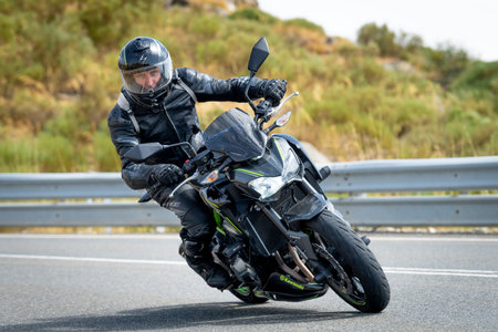 Motorcyclist driving a motorbike on a motorway in Spain.