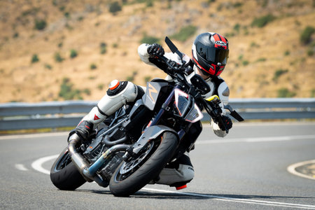 Racing motorcyclist riding on a race track in Spain.
