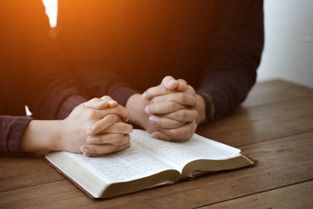 Praying with hands and praying together with religious faith and belief in god on blessing...