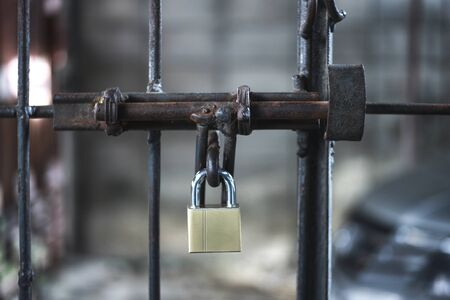 The lock is locked on the old door.の写真素材