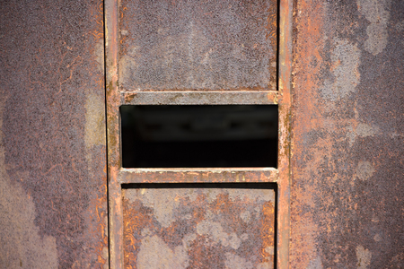 Red rust on the garage door. An old steel door in Asia in Thailand.の写真素材
