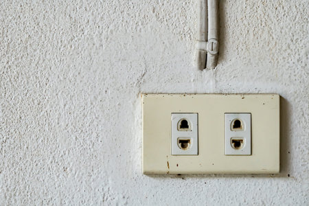 Old Plastic electricity plug on white wall