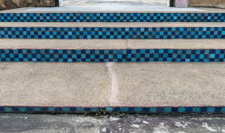 Gravel concrete staircase with blue tiles