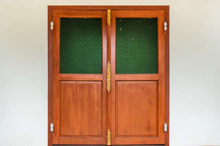 Wooden door on white concrete wallの写真素材