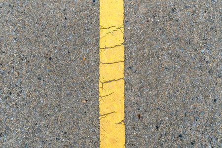 Asphalt road with yellow line texture