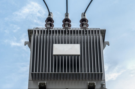 High voltage transformer on blue sky backgroundの写真素材