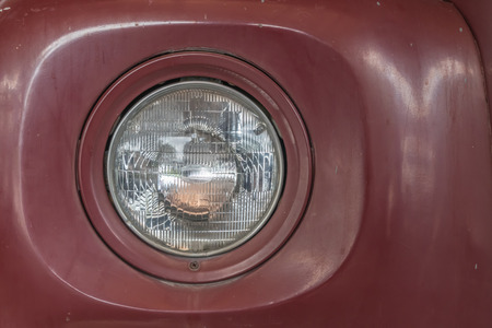 Dark red vintage car headlightの写真素材