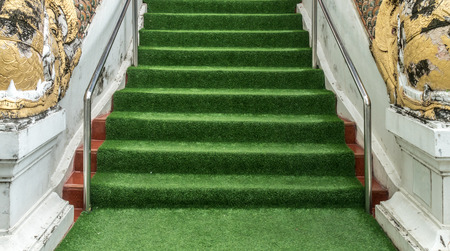 Artificial grass installed over concrete staircase with old Thai's classic style railingの写真素材