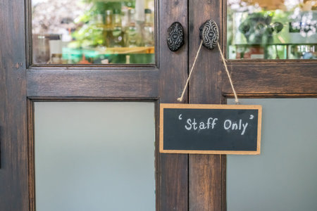 Staff only sign on wooden door