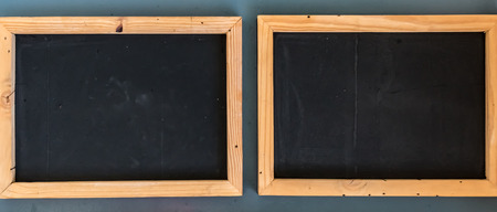 Blank black board with wooden frameの写真素材