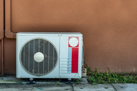 Condenser unit of Air condition on brown wallの写真素材