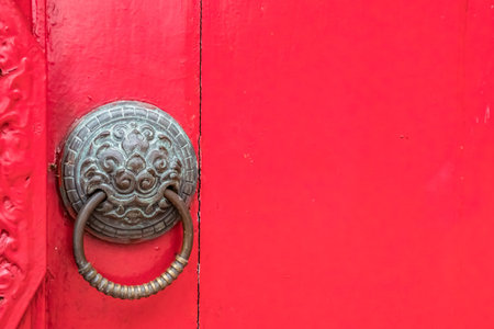 Part of Red wooden Thai's old style doors with iron handle