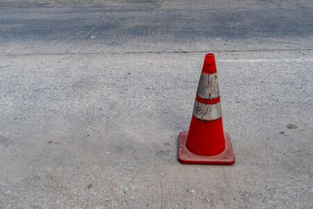 Plastic orange cone on concrete roadの写真素材