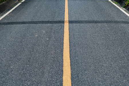 Perspective of Asphalt road with yellow lineの写真素材