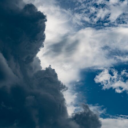 Dark cloud and white cloud with blue skyの写真素材