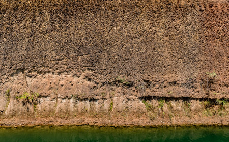 Brown Soil wall with green water