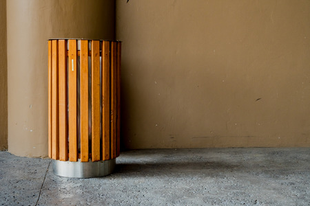 Modern wooden trash on concrete floor and brown concrete wallの写真素材