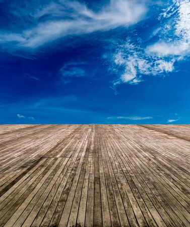 Perspective of Brown old wooden floor with blue sky backgroundの写真素材
