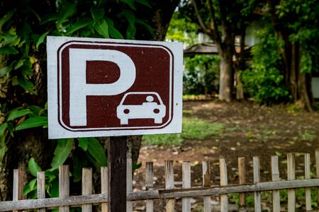 Brown and white car park sign on nature backgroundの写真素材