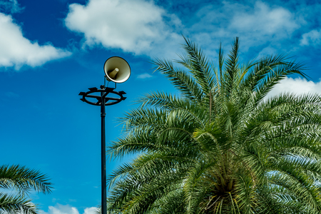 White horn speaker on white cloud background in the parkの写真素材