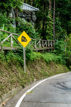 Steep hill traffic sign with asphalt roadの写真素材