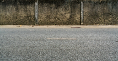 Asphalt road and concrete fenceの写真素材