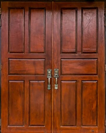 Dark Brown old style wooden door with iron handleの写真素材
