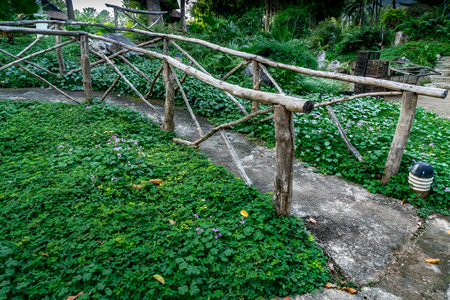 Concrete pathway with branch railing in the parkの写真素材