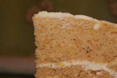 Slice of layered delicious honey cake on rustic wooden background. Homemade bakingの写真素材