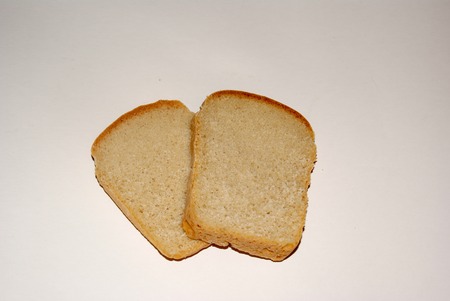 Two slices of whole grain bread isolated on grey backgroundの写真素材
