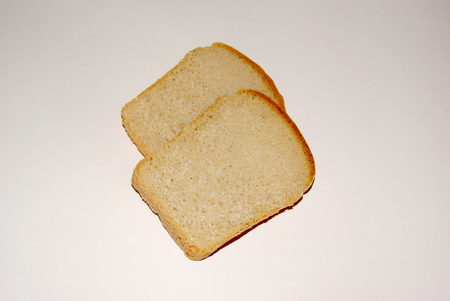 Two slices of whole grain bread isolated on grey backgroundの写真素材