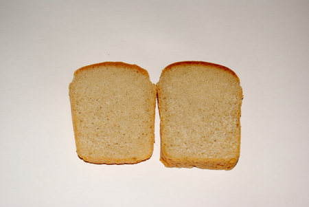 Two slices of whole grain bread isolated on grey backgroundの写真素材