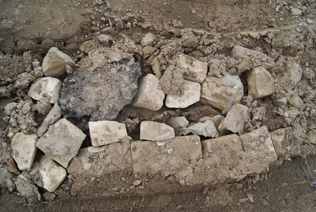 Broken bricks in pile in the Russian bad dirt country roadの写真素材