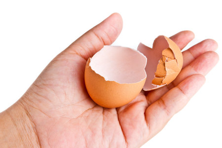 cracked egg in hand on isolated
