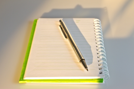 Pen on green notebook in morning moodの写真素材