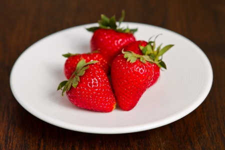 fresh strawberry in white dish on the tableの写真素材