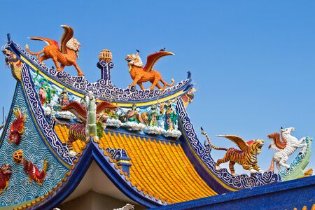 Yellow lions on the roof of chinese templeの写真素材