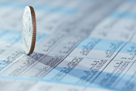 Coins on stock index background Coins on stock index background