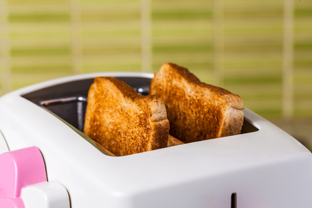 Toast and pink Toaster on green ceramic tileの写真素材