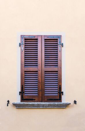 Wooden old window on green wall, Italy styleの写真素材