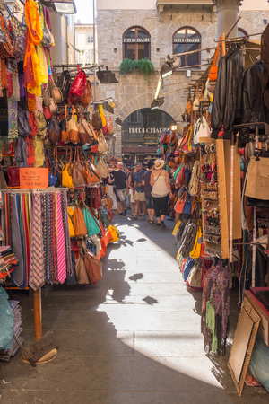 Florence, Italy - July 11, 2015: Tourists shopping lether products at Mercato Nuovo Market, Florence, Tuscany, Italyのeditorial素材