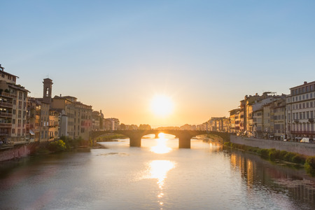 Tourist walking Ponte S.Trinita in sunset, view from Ponte Vecchioの写真素材