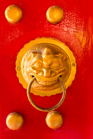 Chinese  handle style on the red doorの写真素材