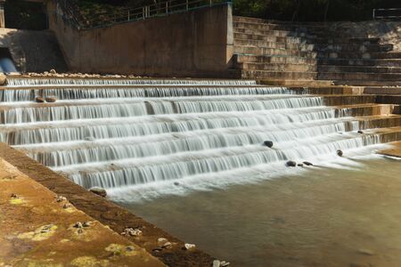 A concrete weir blocks the river to store water for agriculture and consumption. Nan province, northern Thailandの写真素材